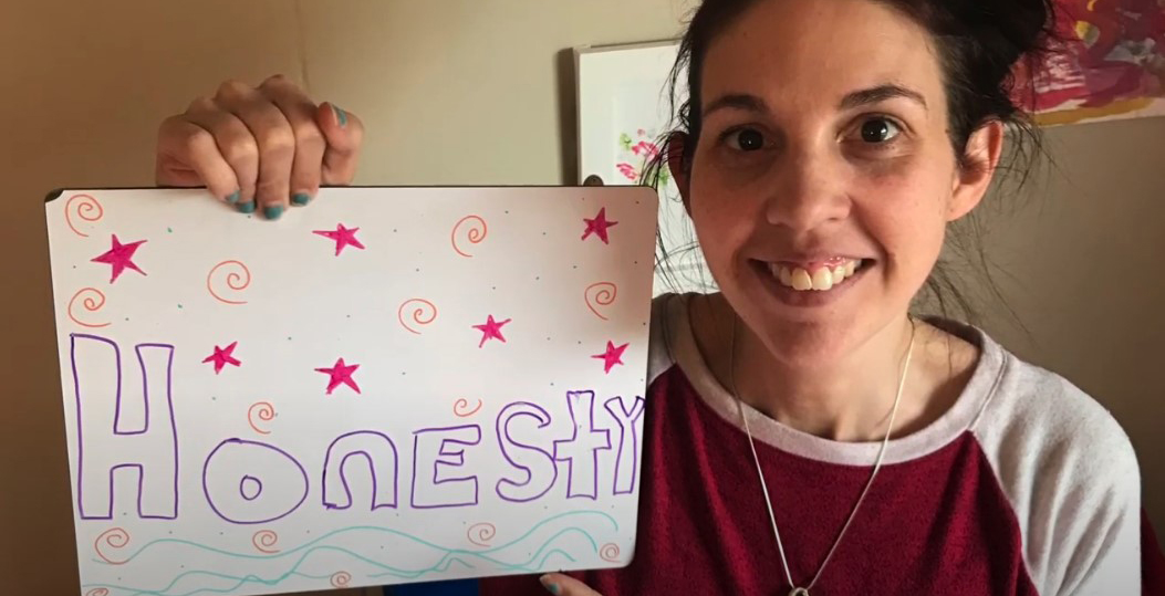 Citizenship Academy Teacher Holding up Character Strength Sign
