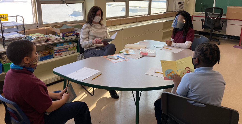 Syracuse Academy of Science and Citizenship elementary school students participated in small breakout reading sessions where they each took turns reading out loud to practice their reading and comprehension skills.