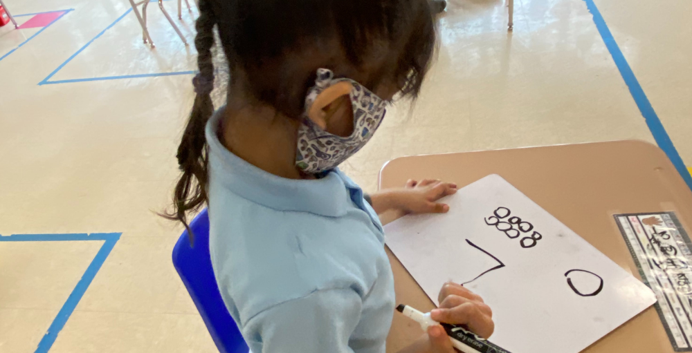 Syracuse Academy of Science and Citizenship kindergarten Atoms in Mrs. Shirvani and Ms. Hence’s class work on their math and critical thinking skills.