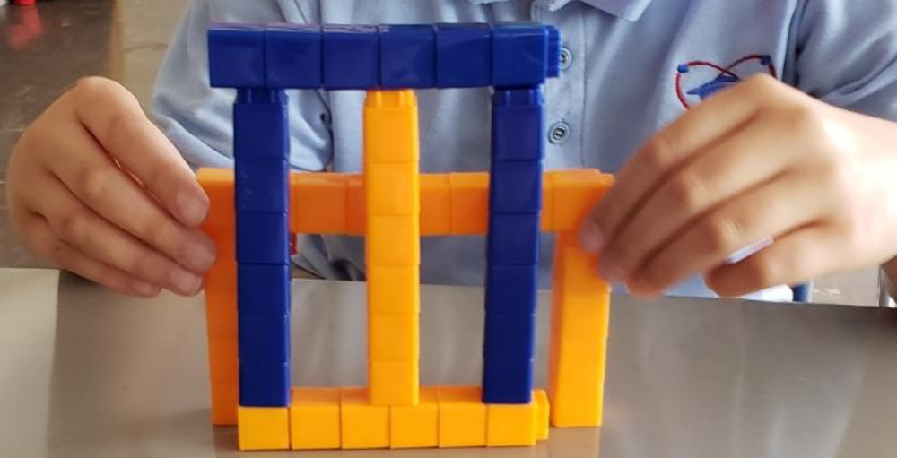 The Syracuse Academy of Science and Citizenship 4th grade students in Mrs. Hebbert’s class put their creativity to the test when creating a symmetrical design using math manipulatives.
