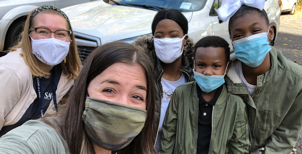 Syracuse Academy of Science and Citizenship elementary teachers complete their home visits while keeping safety in mind.