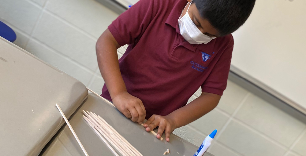 Fourth grade student is constructed a truss bridge made out of balsawood for the MOST’s annual CNY Bridges: Build ‘Em and Bust ‘Em Challenge
