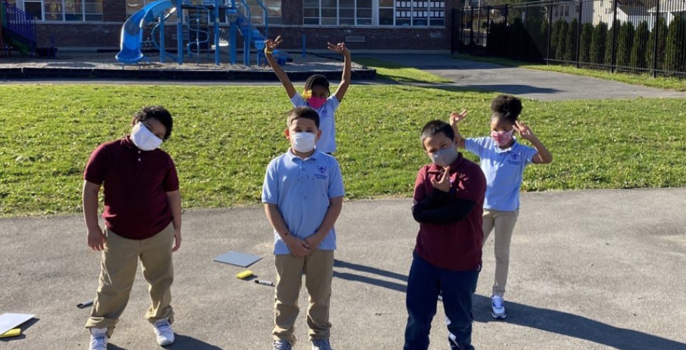Elementary students enjoy the warmth of the weather on an unseasonably warm day in Syracuse, New York.