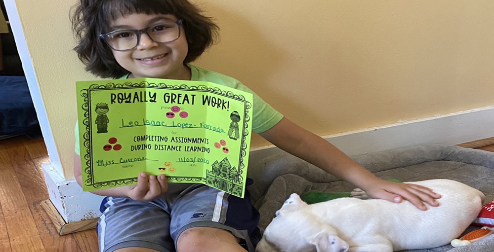 Syracuse Academy of Science and Citizenship school student receives a Royally Great Work certificate for their achievements throughout the first quarter.