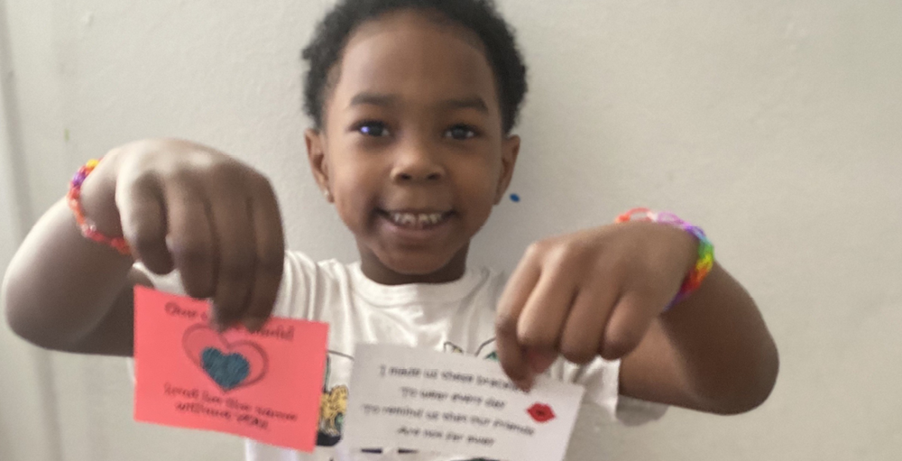A Syracuse Academy of Science and Citizenship student models their friendship bracelets that were mailed to them by their teachers!