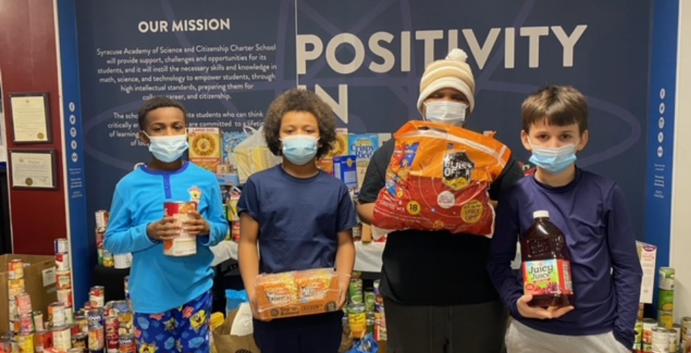 Syracuse Academy of Science and Citizenship elementary school donates 2,147 pounds of non-perishable food items to benefit the Food Bank of Central New York.