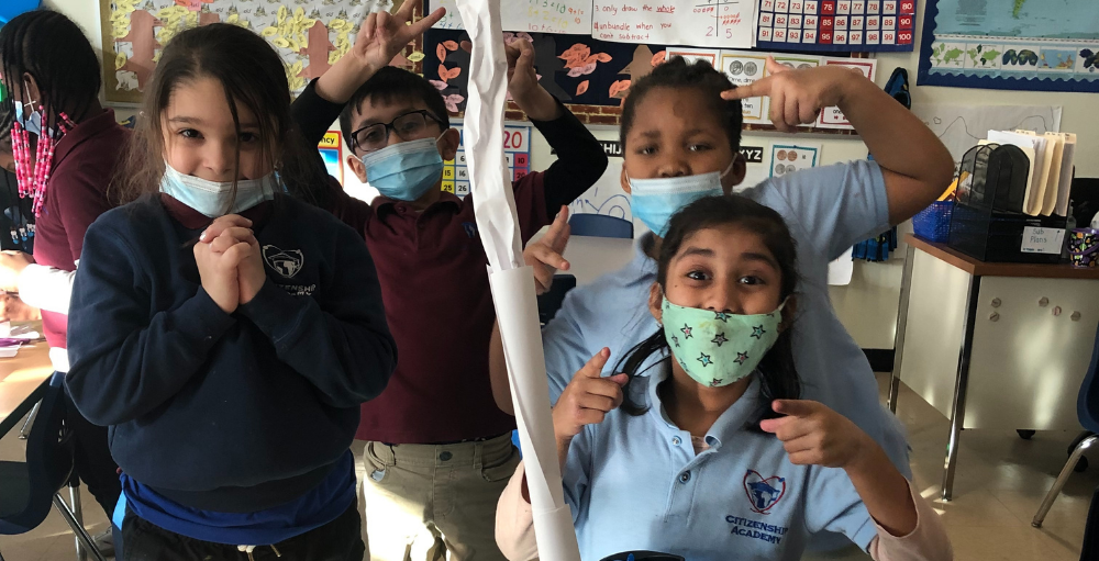 Syracuse Academy of Science and Citizenship 2nd-grade students engineer a paper tower using paper, tape and some glue.
