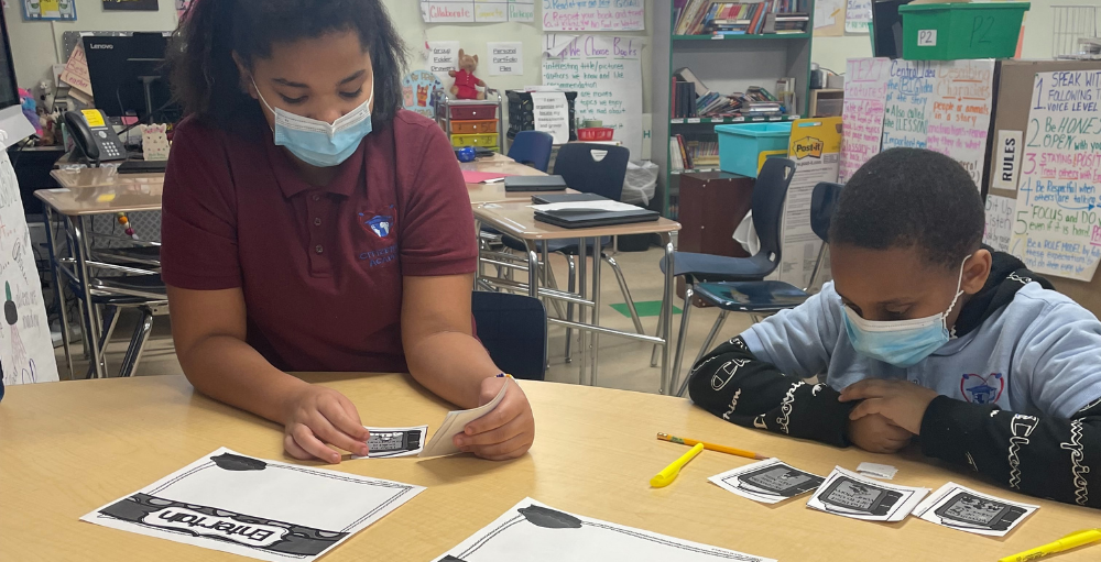 Syracuse Academy of Science and Citizenship 5th grade Atoms work together to sort various book titles into categories of author’s purpose in a reading activity.