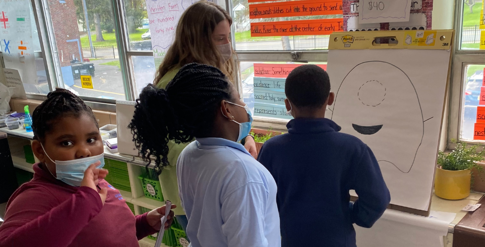 Syracuse Academy of Science and Citizenship 2nd-grade students play Pin the Tail on the Monster during their Fall Festival event.