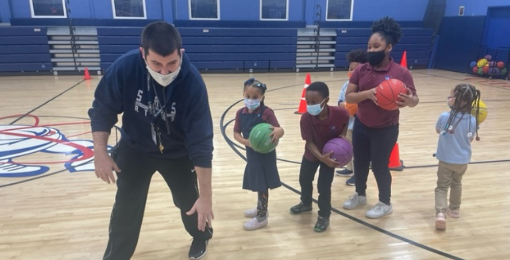 Syracuse Academy of Science and Citizenship elementary school students practice their dribbling skills at their dribbling clinic.