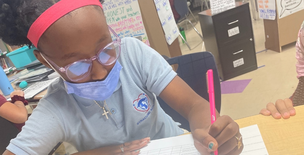Syracuse Academy of Science and Citizenship 6th grade students in Miss Edgar’s reading intervention group practice the R.A.C.E. car writing strategy.