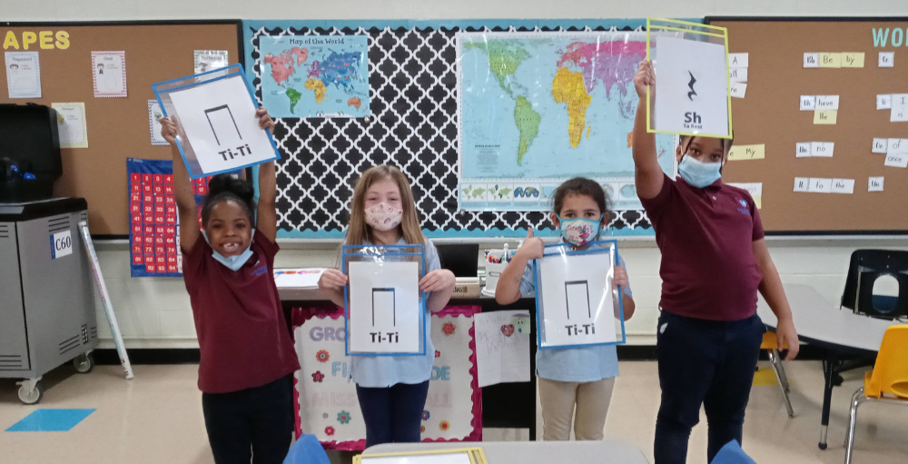 Syracuse Academy of Science and Citizenship elementary school students learn to play various musical instruments, and rhythmic notation in their music class.