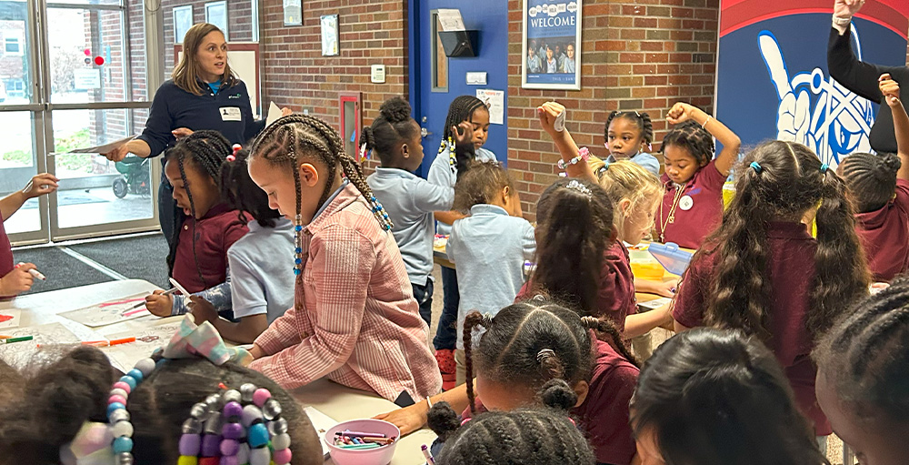 A Guest Speaker from the Girl Scouts Visits Citizenship & Science Academy of Syracuse Atoms