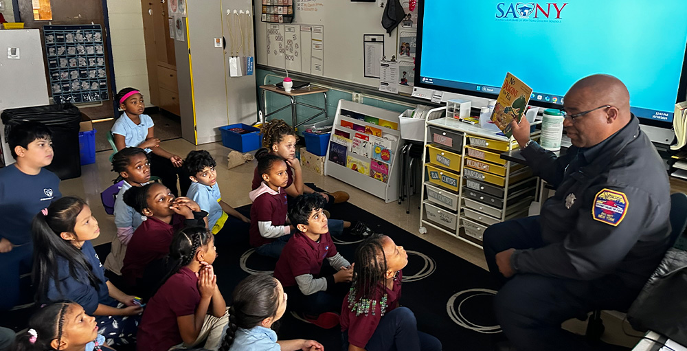 Fire Inspector Gary Butler Reads to Citizenship & Science Academy of Syracuse 4th Gradres